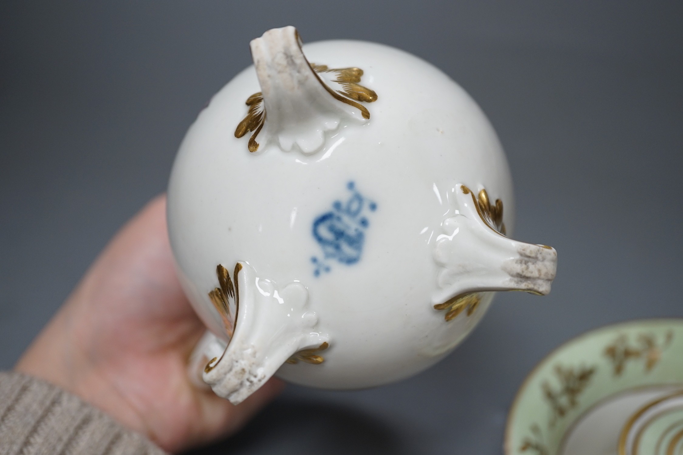 A Ludwigsburg three footed jug and cover painted with swags of flower c. 1770 and a 19th century French porcelain inkwell and cover a colourful gilt floral panel, jug and cover 17 cms high